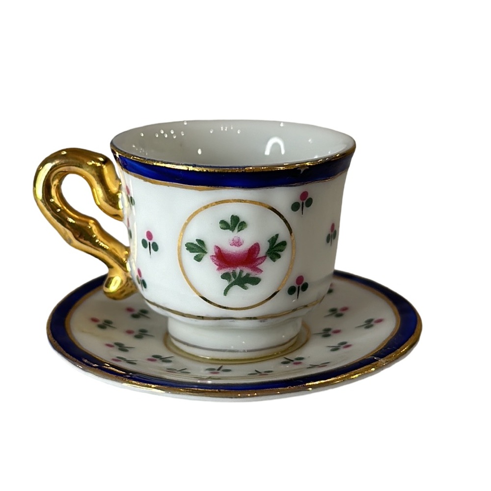 Miniature Gold Rimmed Floral Teacup and Saucer 1 1/2” Tall x 2 3/4 wide.